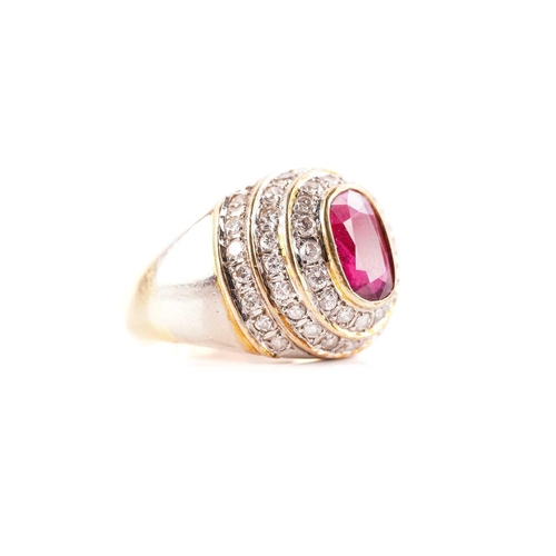 54 - A ruby and diamond dress ring, containing an oval faceted ruby in dark purplish-red colour, approxim... 