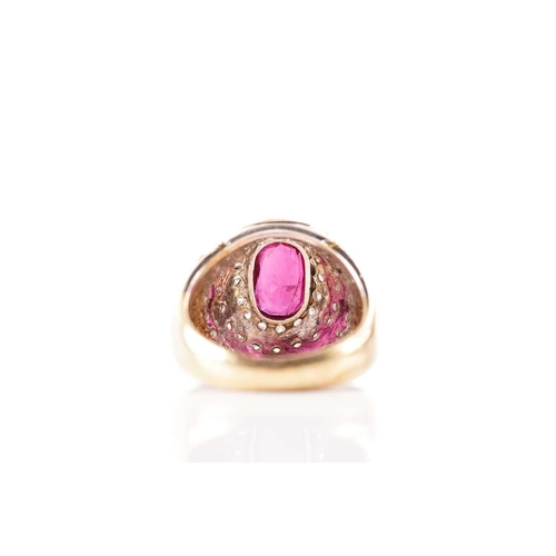 54 - A ruby and diamond dress ring, containing an oval faceted ruby in dark purplish-red colour, approxim... 