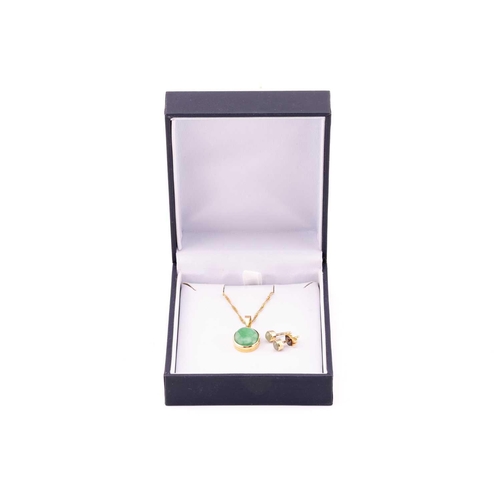 57 - A jade pendant on chain with a pair of stud earrings in 18ct yellow gold; the pendant contains an ov... 