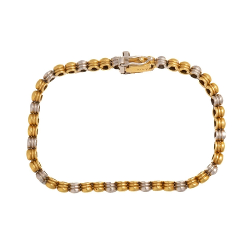 58 - A two-toned line bracelet set with diamonds, each link with a grooved decorated edge and alternating... 