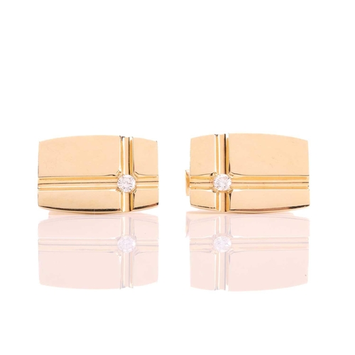 64 - A pair of cufflinks with diamond accents, each comprising a rectangular panel with curved sides, wit... 