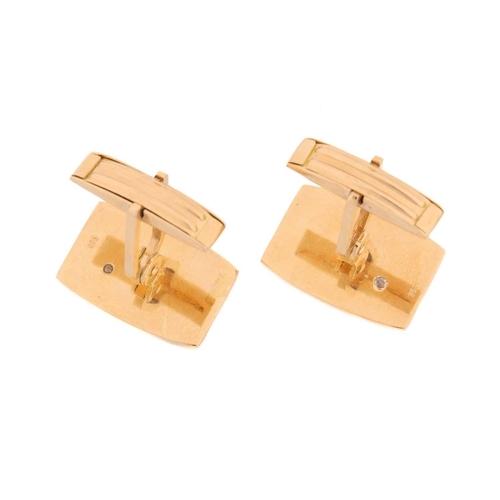 64 - A pair of cufflinks with diamond accents, each comprising a rectangular panel with curved sides, wit... 