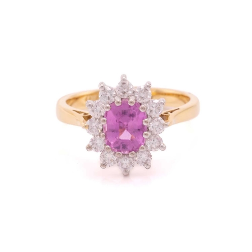 68 - A pink sapphire and diamond cluster ring in 18ct gold, centred with an oval-cut pink sapphire, encir... 