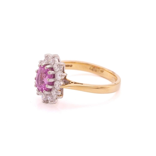 68 - A pink sapphire and diamond cluster ring in 18ct gold, centred with an oval-cut pink sapphire, encir... 