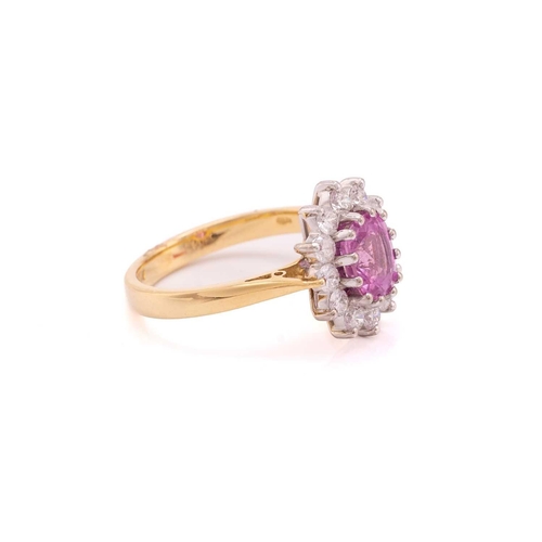 68 - A pink sapphire and diamond cluster ring in 18ct gold, centred with an oval-cut pink sapphire, encir... 