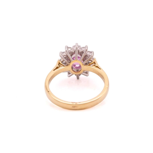 68 - A pink sapphire and diamond cluster ring in 18ct gold, centred with an oval-cut pink sapphire, encir... 