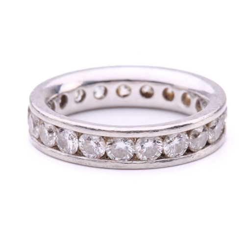 79 - A diamond eternity ring in platinum, containing twenty-one round brilliant-cut diamonds of 3.0 mm, c... 