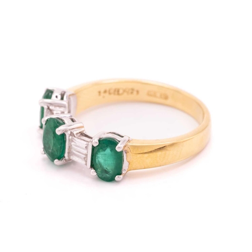 8 - An emerald and diamond dress ring in 18ct bi-coloured gold, comprising three oval-cut emeralds in cl... 