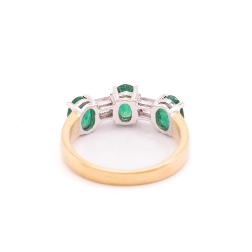 8 - An emerald and diamond dress ring in 18ct bi-coloured gold, comprising three oval-cut emeralds in cl... 