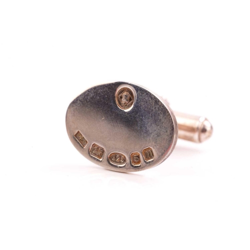 82 - Two pairs of silver cufflinks; the pair of oval cufflinks with feature marks on the panel, are fitte... 