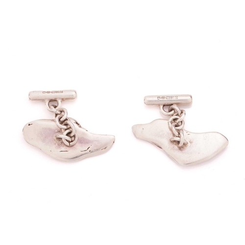 82 - Two pairs of silver cufflinks; the pair of oval cufflinks with feature marks on the panel, are fitte... 