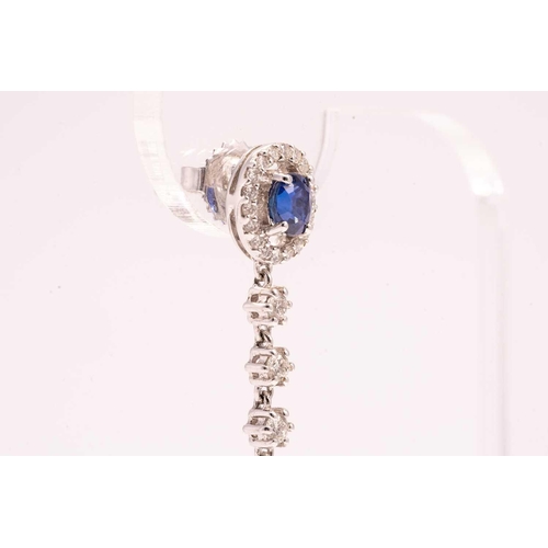 84 - A pair of sapphire and diamond drop earrings, each with a pear cut sapphire and an oval mixed cut sa... 