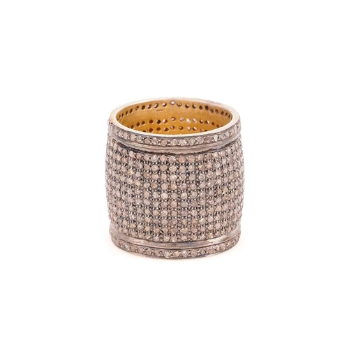 88 - A diamond pave set ring, the deep band grain set throughout with light brown round cut diamonds to a... 