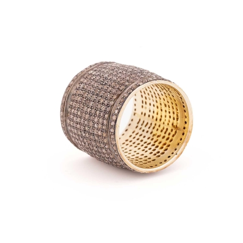 88 - A diamond pave set ring, the deep band grain set throughout with light brown round cut diamonds to a... 