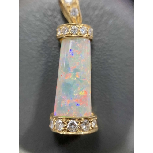 94 - An opal and diamond pendant, the tapering rectangular opal cabochon, with good blue/orange play of c... 