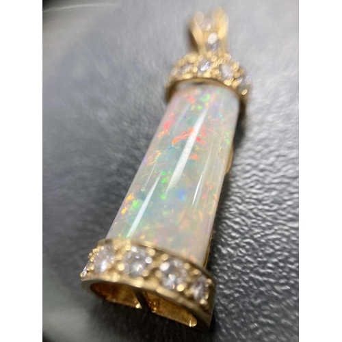 94 - An opal and diamond pendant, the tapering rectangular opal cabochon, with good blue/orange play of c... 