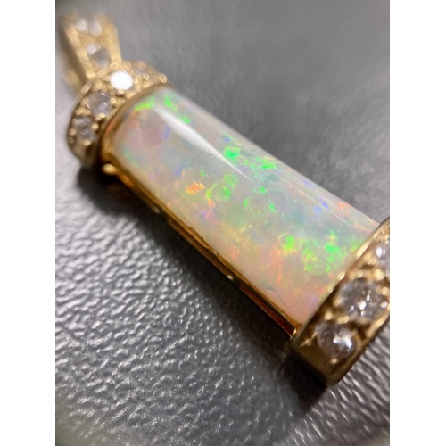 94 - An opal and diamond pendant, the tapering rectangular opal cabochon, with good blue/orange play of c... 