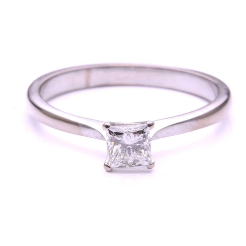 97 - A single stone diamond ring; the princess cut diamond in four claw mount to a plain 18-carat white g... 