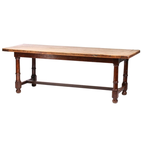 108 - A French rustic oak farmhouse table, 19th century, with cleated scrubbed plank top, supported by sub... 