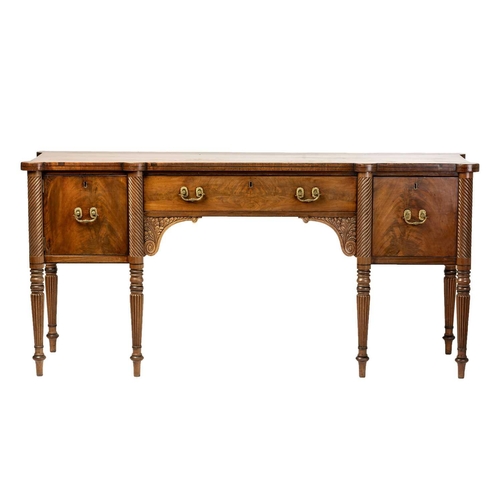 117 - A Regency mahogany sideboard, the rectangular top with rounded corners and ebony strung edge over a ... 