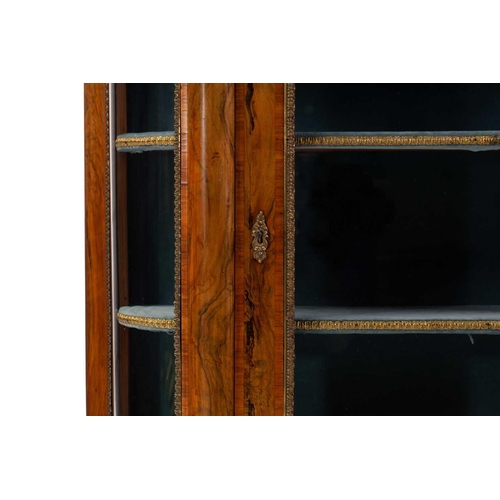 119 - A Victorian figured walnut credenza with a tulipwood banded figured top above a central glazed door ... 