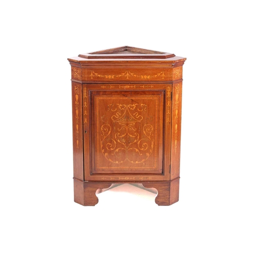 123 - An Edwardian mahogany and Neo-Classical marquetry inlaid freestanding corner display cabinet, in the... 