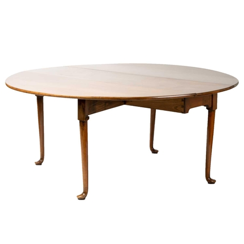 141 - A George II style walnut gateleg dining table, by David Prue for Brights of Nettlebed, the oval hing... 