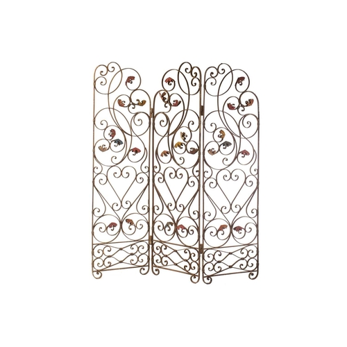 142 - An Italianate wrought iron three panel room screen, 20th century ,with verdigris painted scrolling t... 