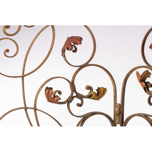 142 - An Italianate wrought iron three panel room screen, 20th century ,with verdigris painted scrolling t... 