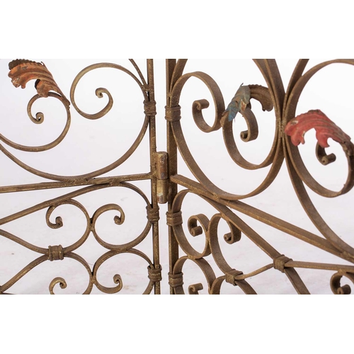 142 - An Italianate wrought iron three panel room screen, 20th century ,with verdigris painted scrolling t... 