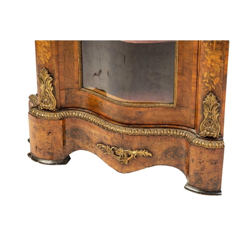 153 - An unusual Victorian Circassian walnut corner display cabinet (adapted) with single glazed serpentin... 