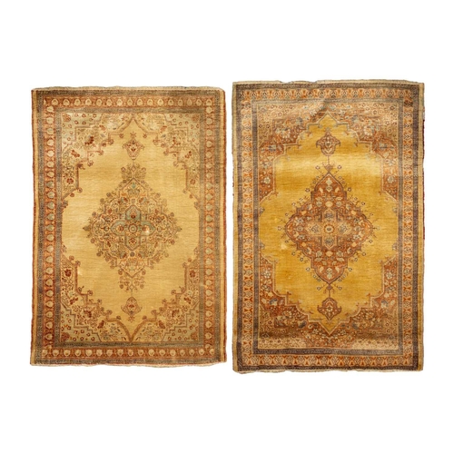 155 - A matched pair of golden ground Turkish silk on silk mats, early 20th century, with central lozenge ... 