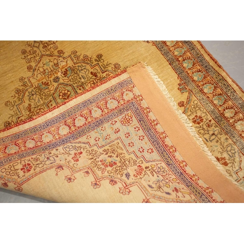 155 - A matched pair of golden ground Turkish silk on silk mats, early 20th century, with central lozenge ... 