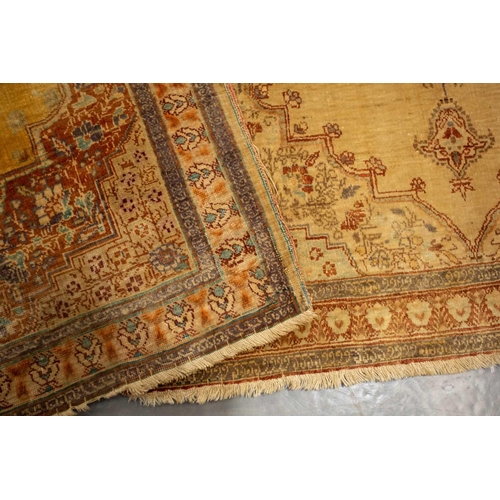 155 - A matched pair of golden ground Turkish silk on silk mats, early 20th century, with central lozenge ... 