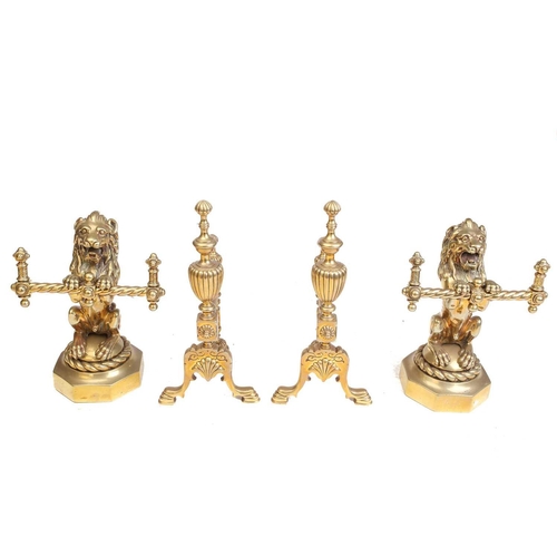 172 - A pair of Victorian cast and gilt brass heraldic sejant erect lion firedogs, each holding a decorati... 