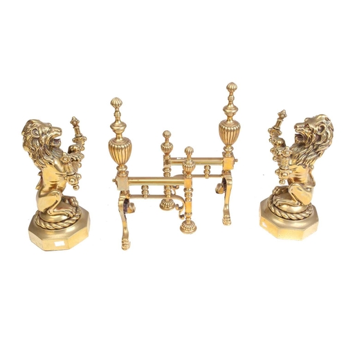 172 - A pair of Victorian cast and gilt brass heraldic sejant erect lion firedogs, each holding a decorati... 