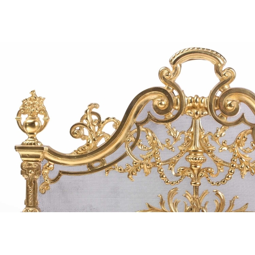 173 - A Louis XVI-style heavy ormolu spark guard, late 20th century, with a shaped arch top above a pieced... 