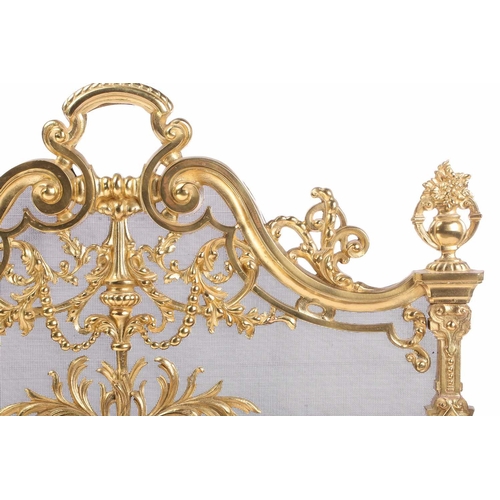 173 - A Louis XVI-style heavy ormolu spark guard, late 20th century, with a shaped arch top above a pieced... 