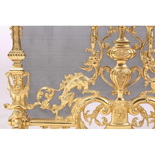 173 - A Louis XVI-style heavy ormolu spark guard, late 20th century, with a shaped arch top above a pieced... 