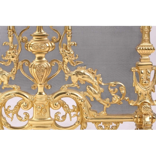 173 - A Louis XVI-style heavy ormolu spark guard, late 20th century, with a shaped arch top above a pieced... 