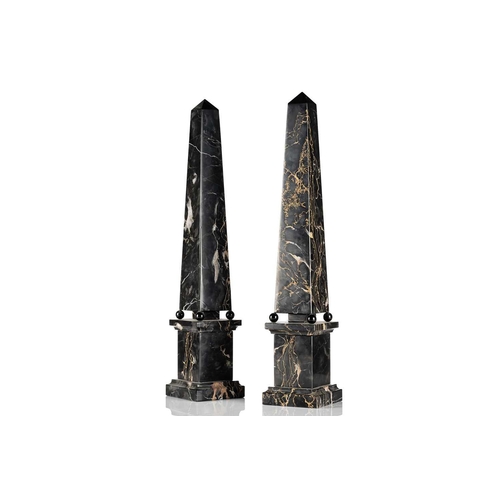 174 - A pair of variegated black marble obelisks, on ball feet and plinth bases, late 20th century, 52.5 c... 