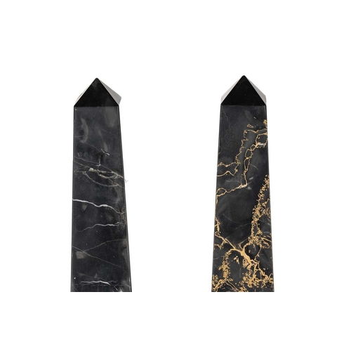 174 - A pair of variegated black marble obelisks, on ball feet and plinth bases, late 20th century, 52.5 c... 