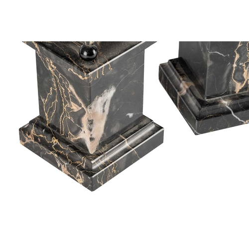 174 - A pair of variegated black marble obelisks, on ball feet and plinth bases, late 20th century, 52.5 c... 