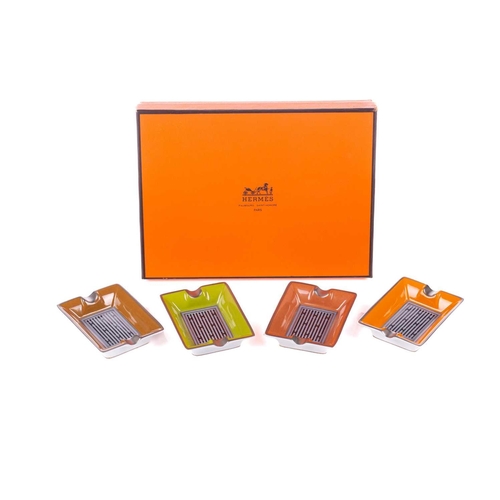 179 - A presentation boxed Hermes of Paris set of four porcelain individual ashtrays in colours with styli... 