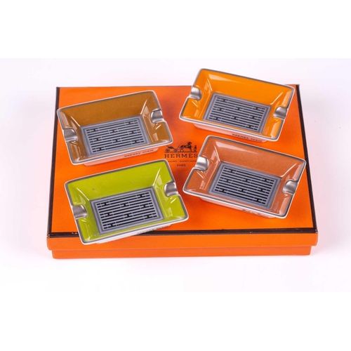 179 - A presentation boxed Hermes of Paris set of four porcelain individual ashtrays in colours with styli... 