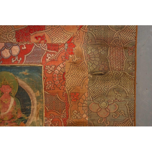 80 - A Tibetan Thangka, early 20th century, Sakyamuni Buddha, seated on a cloud cushion within a garden s... 