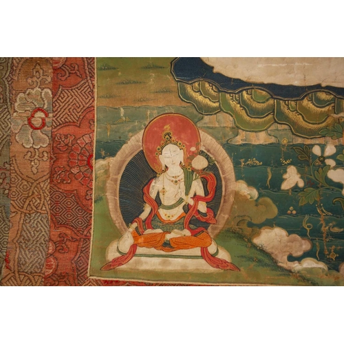 80 - A Tibetan Thangka, early 20th century, Sakyamuni Buddha, seated on a cloud cushion within a garden s... 