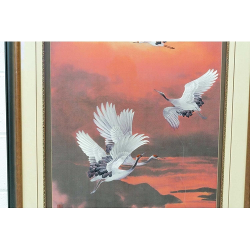 84 - A large Japanese embroidered picture of cranes in flight, 20th century, 98 cm x 57 cm framed and gla... 