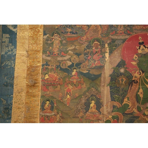 92 - A Tibetan Green Tara - sGrol-ma, possibly 18th century, surrounded by buddhas, divinities and Dalai ... 