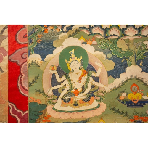 99 - A Tibetan Thangka of Amitayus, early 20th century, seated within a gilt sunburst halo, with deities,... 